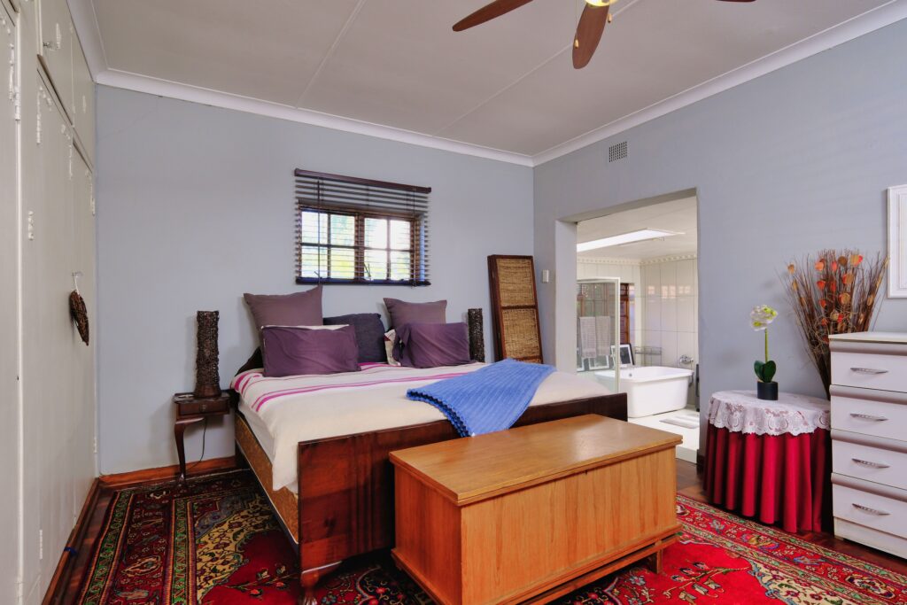 Spacious bedroom featuring stylish decor and cozy elements for a comfortable living experience.