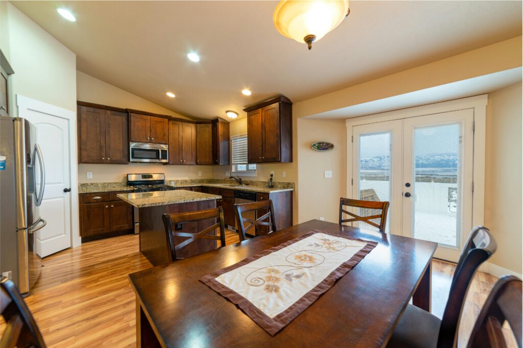 Spacious kitchen and dining area featuring modern appliances and wooden cabinets.